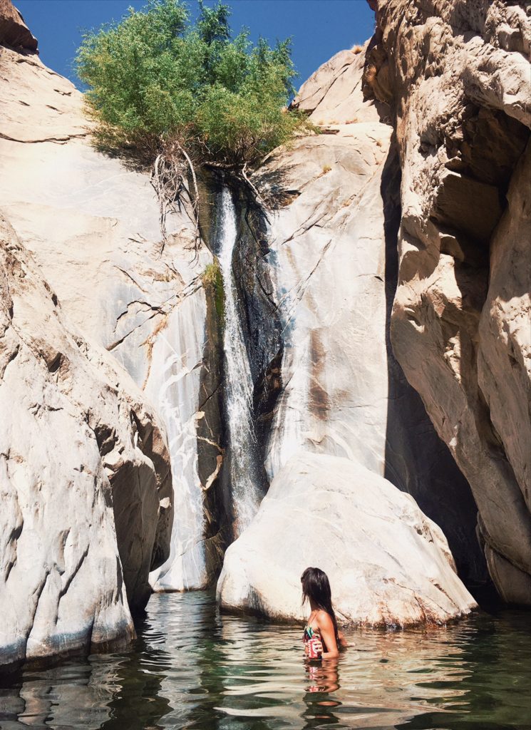 Young woman in water at Tahquitz Canyon Waterfall